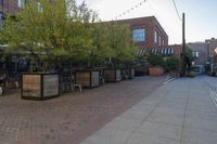 the courtyard with tree in front and small seatings in the front area on the sidewalk