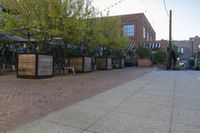 the courtyard with tree in front and small seatings in the front area on the sidewalk