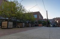 the courtyard with tree in front and small seatings in the front area on the sidewalk