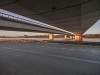 City at Dawn with Coastal Road and Bridge over Ocean