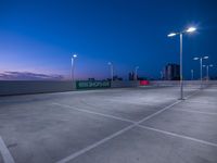 the empty parking lot is illuminated by streetlights and bright lights, all lit up