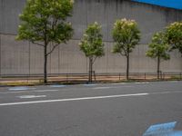 empty road with white lines on the streets of city area against cloudy blue sky on a sunny day