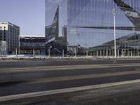 this is a view of the modern city building near the road side with snow on the ground