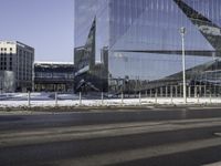 this is a view of the modern city building near the road side with snow on the ground