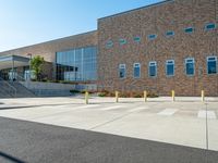 there is a sidewalk outside a high school building with stairs going up and down it