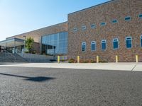 there is a sidewalk outside a high school building with stairs going up and down it