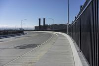 the highway leading to a big bridge and two towers near it and one with two cars on it