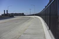 the highway leading to a big bridge and two towers near it and one with two cars on it