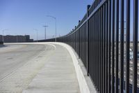 the highway leading to a big bridge and two towers near it and one with two cars on it