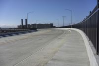 the highway leading to a big bridge and two towers near it and one with two cars on it