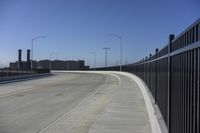 the highway leading to a big bridge and two towers near it and one with two cars on it