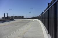 the highway leading to a big bridge and two towers near it and one with two cars on it