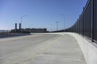 the highway leading to a big bridge and two towers near it and one with two cars on it