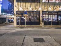 a bus stop with a blue cross walk sign and the exit sign for an underground subway station