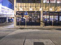 a bus stop with a blue cross walk sign and the exit sign for an underground subway station