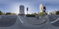 an 360 - degree shot of a city intersection with street lights and an urban street with tall buildings on one side and a street at the other side