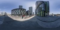 a city intersection is pictured from the 360 - camera lens of a skateboarder