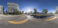 a fish eye view of an intersection in a city, looking like an upside down shot