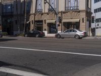 people are walking down the road near a store with blue and white awnings