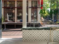 a white tiled floor near glass doors and windows with people sitting on the sidewalk in front