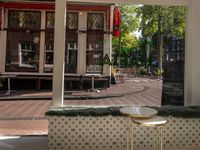 a white tiled floor near glass doors and windows with people sitting on the sidewalk in front