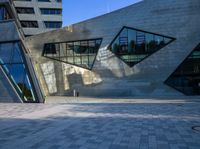 the buildings are made from concrete and glass on a clear day that is reflecting the sky