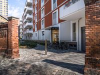 this is an image of the entrance of a building with bicycles parked on it's sidewalks