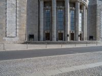 an entrance of a building with large columns and doors that spell out the word voltege