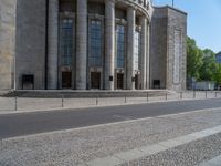 an entrance of a building with large columns and doors that spell out the word voltege