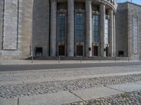 an entrance of a building with large columns and doors that spell out the word voltege