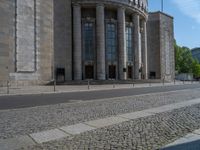 an entrance of a building with large columns and doors that spell out the word voltege