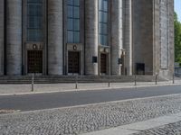 an entrance of a building with large columns and doors that spell out the word voltege