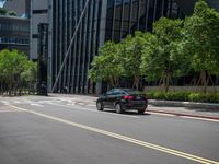 there is an empty street in the middle of a city area with tall buildings on either side