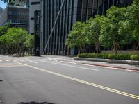 there is an empty street in the middle of a city area with tall buildings on either side