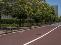 empty road with white lines on the streets of city area against cloudy blue sky on a sunny day