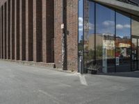 a traffic light is in front of an entrance to a building that has glass windows