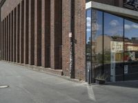 a traffic light is in front of an entrance to a building that has glass windows