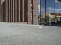 a traffic light is in front of an entrance to a building that has glass windows