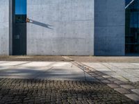 a gray wall with a small line of street lights on it's sides and in the middle of some concrete