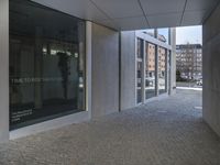 an entrance to a building with the word time to decide the future written on glass