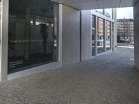 an entrance to a building with the word time to decide the future written on glass