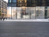 there are buildings and a traffic light in the reflection of glass doors of this building