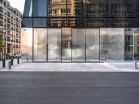 there are buildings and a traffic light in the reflection of glass doors of this building