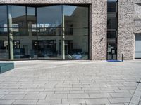 a person sitting on a bench with a book on it's side looking out at the buildings