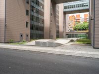 concrete blocks on the sidewalk of a building with a skateboard ramp attached to it