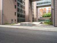 concrete blocks on the sidewalk of a building with a skateboard ramp attached to it