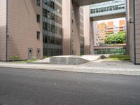 concrete blocks on the sidewalk of a building with a skateboard ramp attached to it