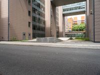 concrete blocks on the sidewalk of a building with a skateboard ramp attached to it