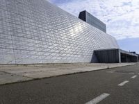 an image of the exterior of a building with white and grey colored tile on it