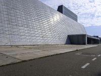 an image of the exterior of a building with white and grey colored tile on it